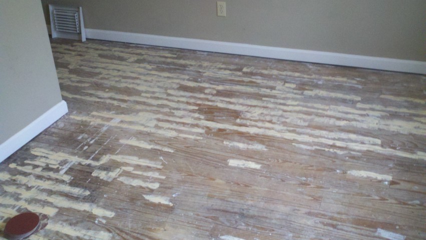 A damaged wood floor showing signs of severe scratches and scuffs